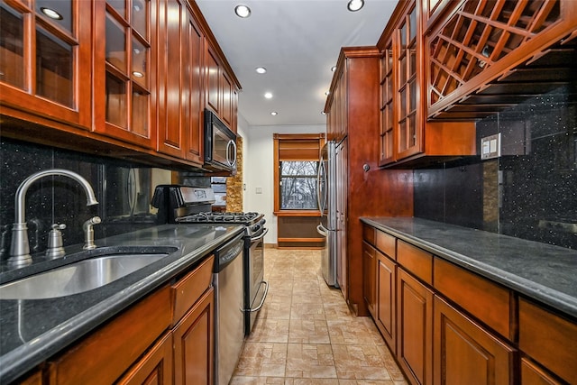 kitchen with tasteful backsplash, appliances with stainless steel finishes, and sink