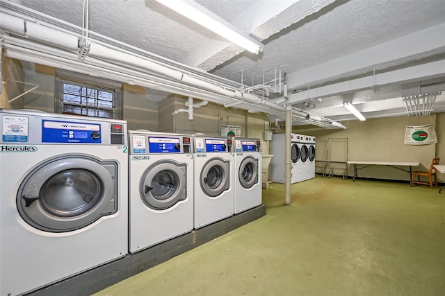 laundry area featuring washing machine and clothes dryer and a textured ceiling