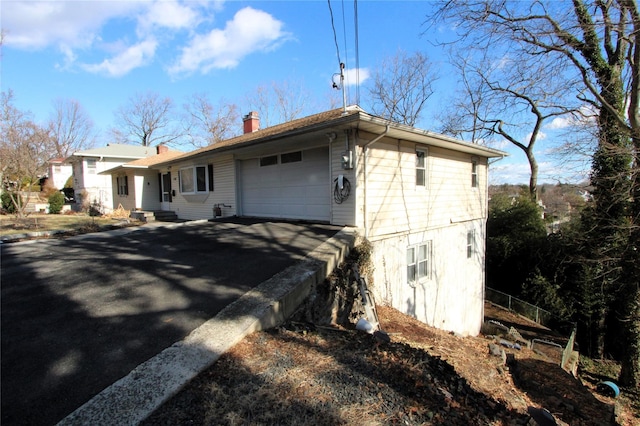 back of property featuring a garage