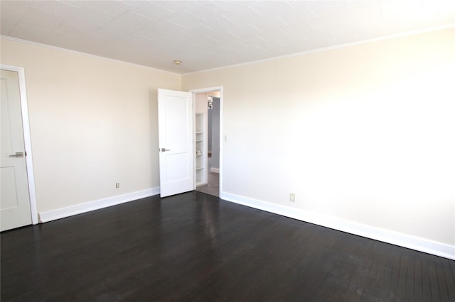 unfurnished room with ornamental molding and dark hardwood / wood-style floors