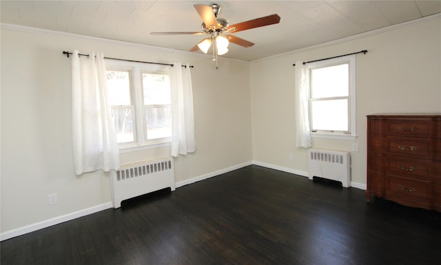 empty room featuring ornamental molding, radiator heating unit, and plenty of natural light