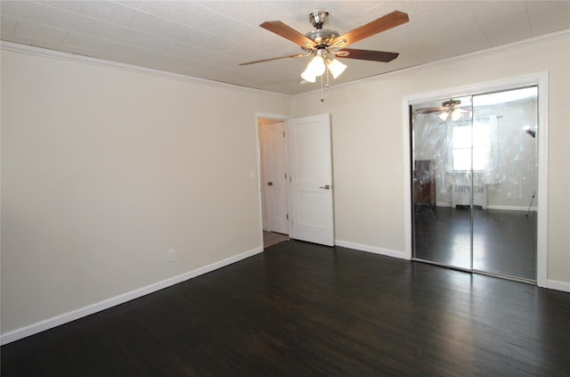 unfurnished bedroom with crown molding, dark wood-type flooring, a closet, and ceiling fan