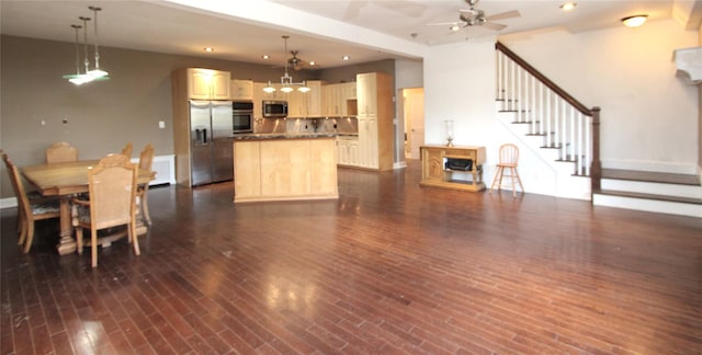 kitchen with a center island, hanging light fixtures, dark hardwood / wood-style floors, ceiling fan, and stainless steel appliances