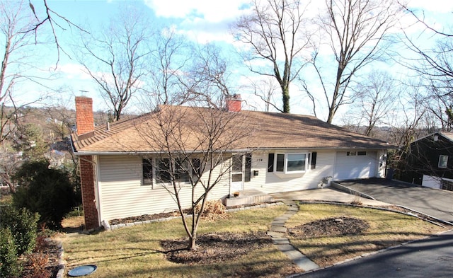 single story home featuring a garage and a front yard