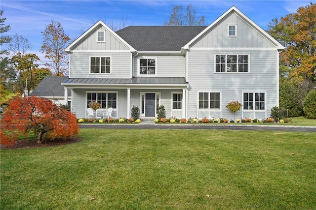 view of front facade featuring covered porch and a front yard