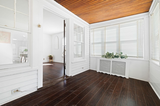 interior space featuring radiator, wood ceiling, and dark hardwood / wood-style flooring