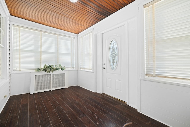 foyer with vaulted ceiling, radiator, wooden ceiling, and dark hardwood / wood-style flooring