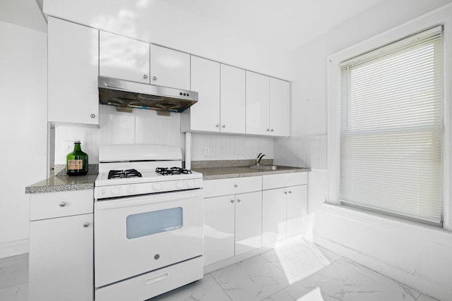 kitchen featuring white cabinets, sink, and white gas stove