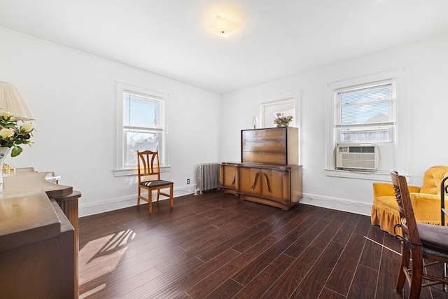 sitting room with radiator, cooling unit, and dark hardwood / wood-style flooring