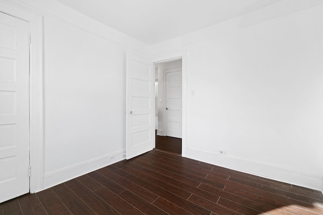 empty room featuring dark hardwood / wood-style flooring