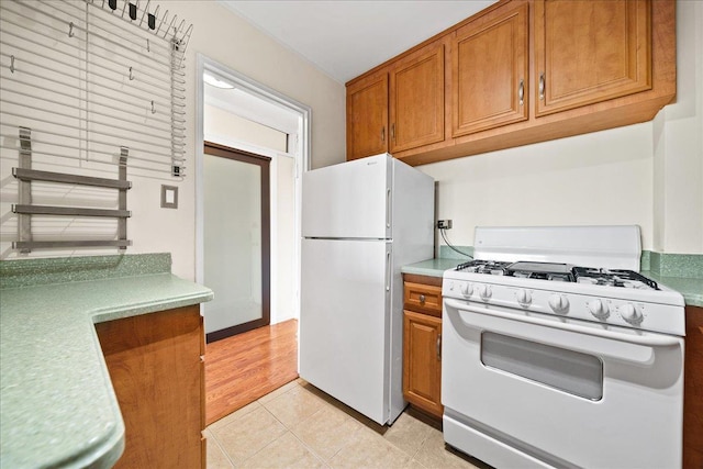 kitchen with light tile patterned floors and white appliances