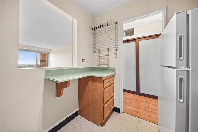 kitchen featuring white fridge and light tile patterned floors