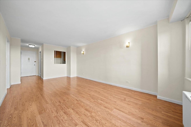 unfurnished room with light wood-type flooring