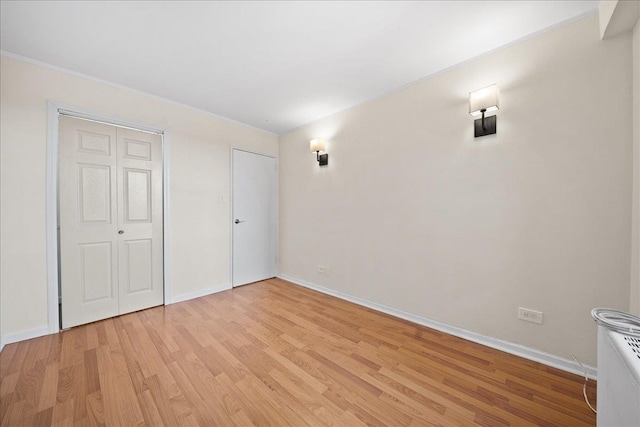 unfurnished bedroom featuring light hardwood / wood-style floors and a closet