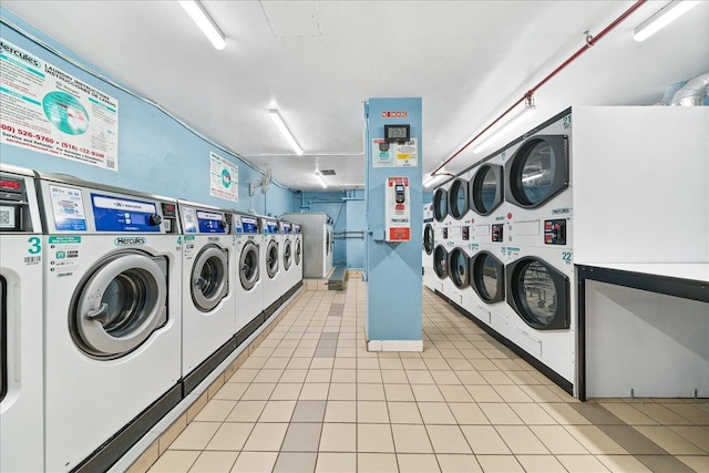 laundry room featuring light tile patterned floors, washing machine and clothes dryer, and stacked washer / dryer