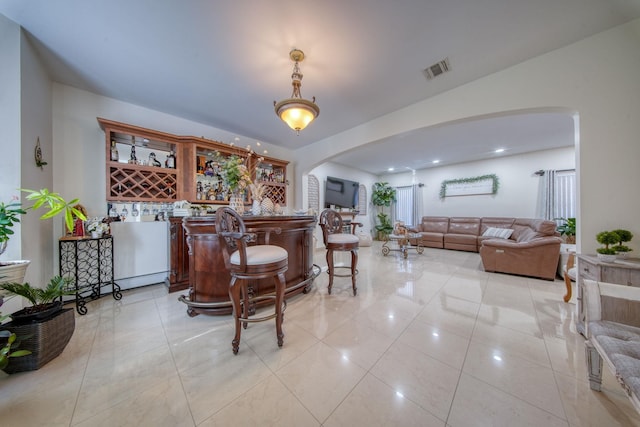 bar featuring light tile patterned floors