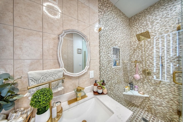 bathroom featuring vanity and tile walls