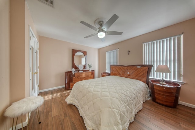 bedroom with hardwood / wood-style flooring and ceiling fan