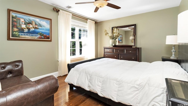 bedroom with ceiling fan and dark hardwood / wood-style flooring