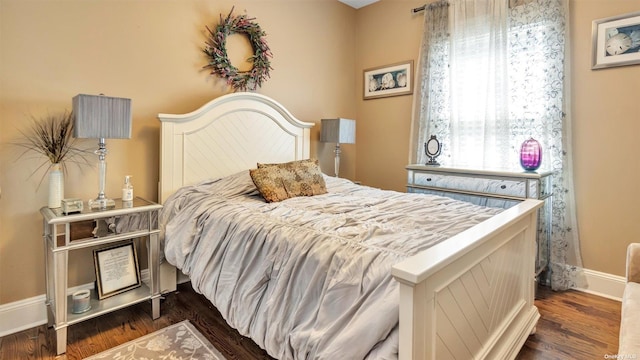 bedroom with dark hardwood / wood-style flooring