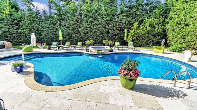 view of swimming pool featuring a patio and an in ground hot tub