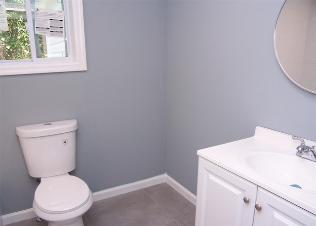 bathroom with tile patterned floors, vanity, and toilet