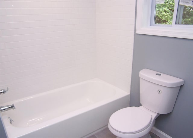 bathroom featuring tile patterned flooring, toilet, and shower / bath combination