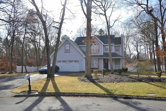 view of front property featuring a garage and a front yard