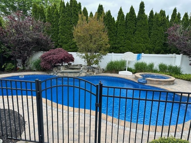 view of pool featuring an in ground hot tub