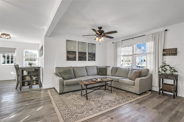 living room with wood-type flooring and ceiling fan