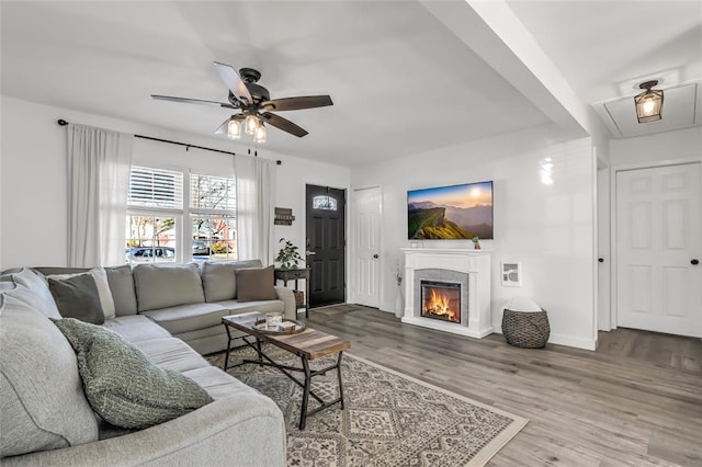 living room featuring hardwood / wood-style floors and ceiling fan