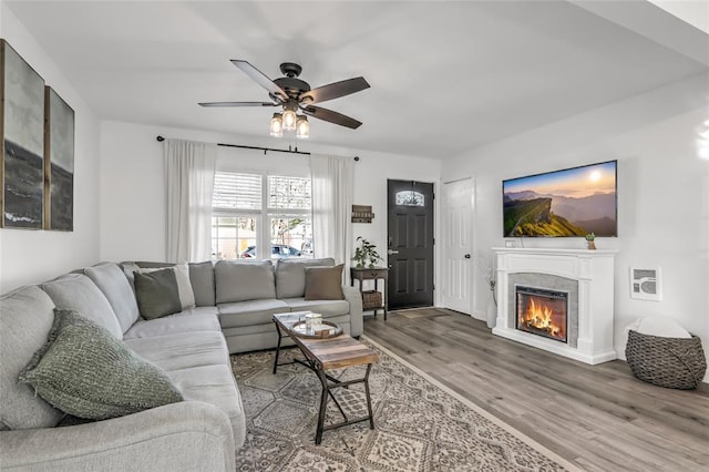 living room featuring wood-type flooring and ceiling fan