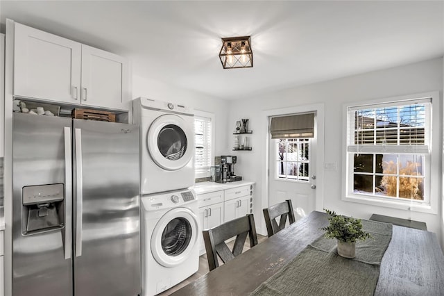 clothes washing area with stacked washer and dryer