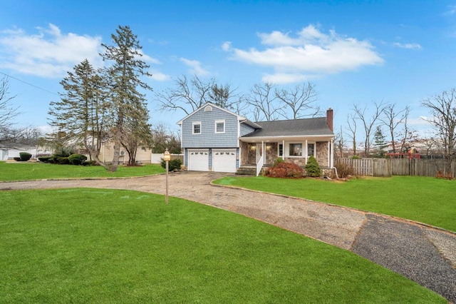 tri-level home featuring a garage, a front lawn, and covered porch