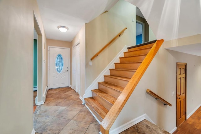 foyer featuring a baseboard heating unit