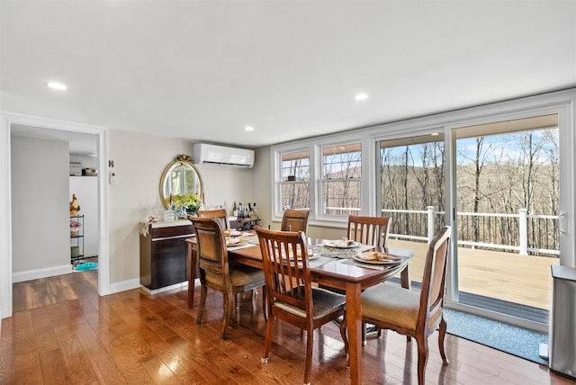 dining room featuring hardwood / wood-style floors and a wall mounted air conditioner