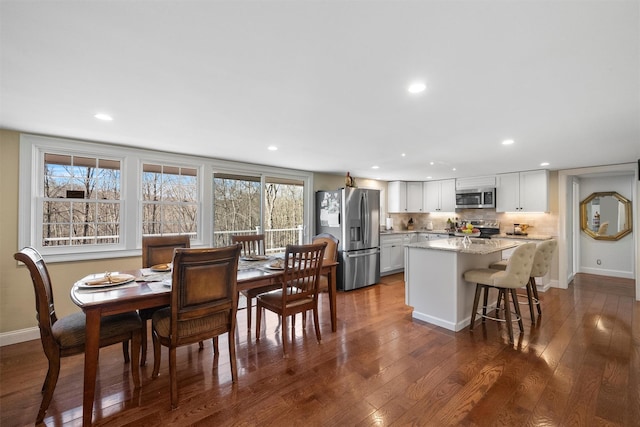 dining area featuring dark hardwood / wood-style floors