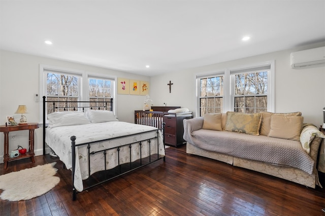 bedroom with multiple windows, dark wood-type flooring, and a wall mounted AC