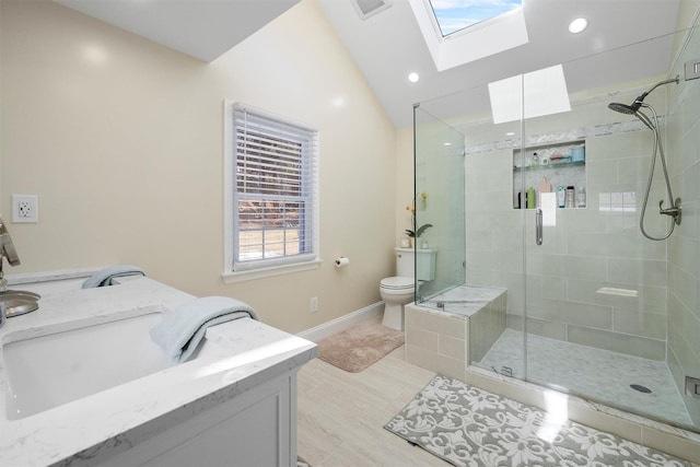 bathroom with vanity, an enclosed shower, lofted ceiling with skylight, and toilet