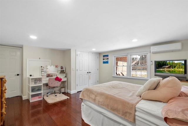 bedroom featuring dark hardwood / wood-style flooring and a wall mounted AC