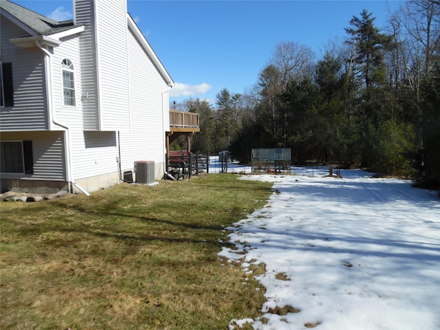 yard covered in snow featuring central AC unit