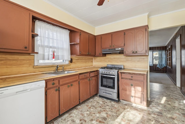 kitchen featuring stainless steel gas stove, sink, ornamental molding, ceiling fan, and white dishwasher