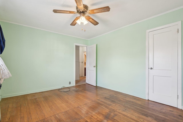 unfurnished room with hardwood / wood-style floors, crown molding, and ceiling fan