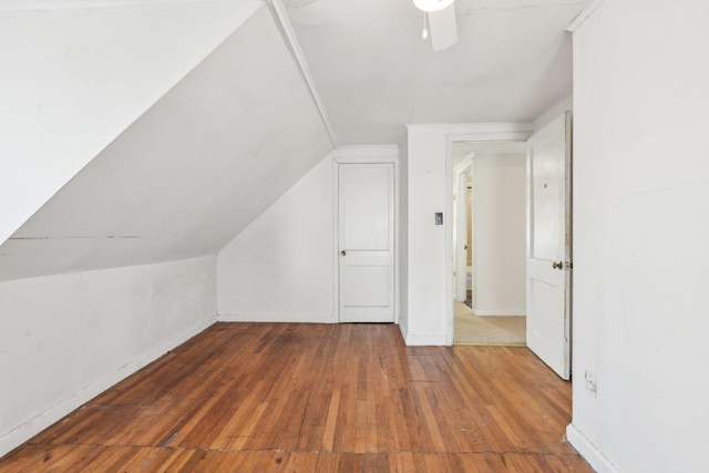 bonus room featuring vaulted ceiling and dark wood-type flooring