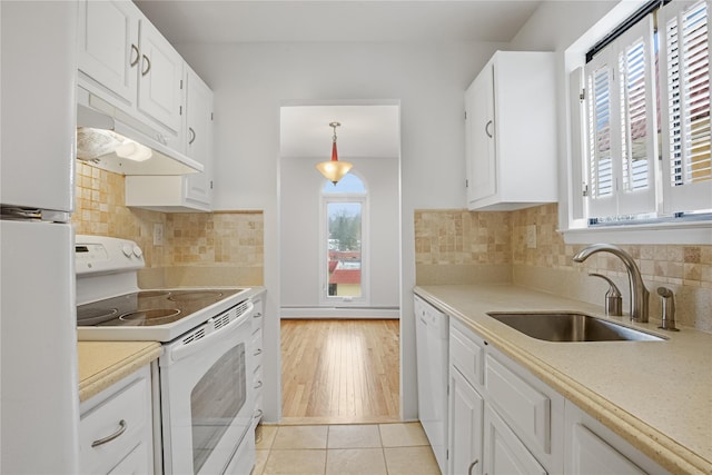 kitchen with light tile patterned flooring, sink, white cabinets, hanging light fixtures, and white appliances