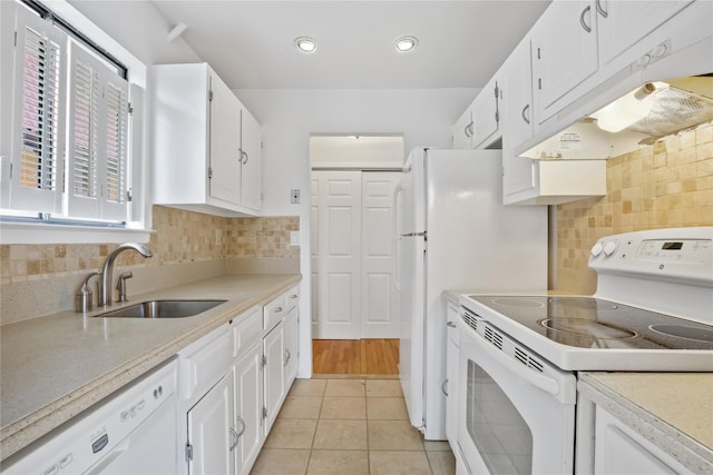 kitchen featuring white cabinetry, sink, light tile patterned floors, and white appliances