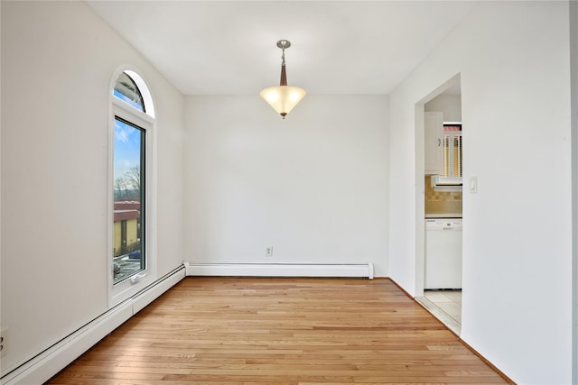 unfurnished dining area featuring baseboard heating and light hardwood / wood-style flooring