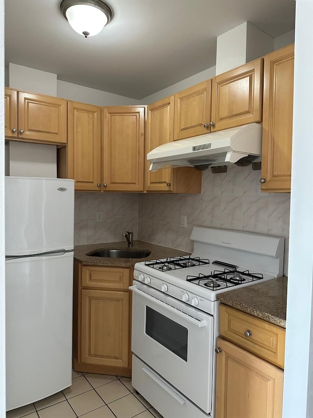 kitchen with tasteful backsplash, sink, white appliances, and light tile patterned floors