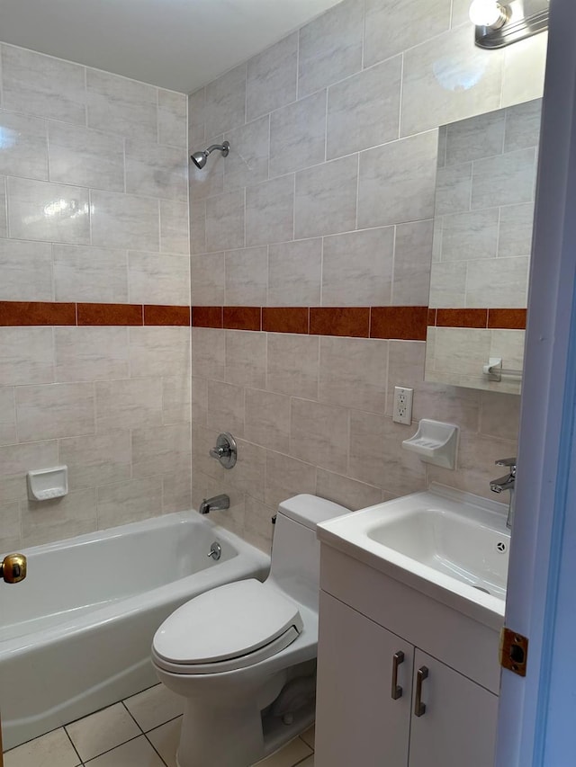 full bathroom featuring tile walls, tiled shower / bath combo, vanity, tile patterned floors, and toilet