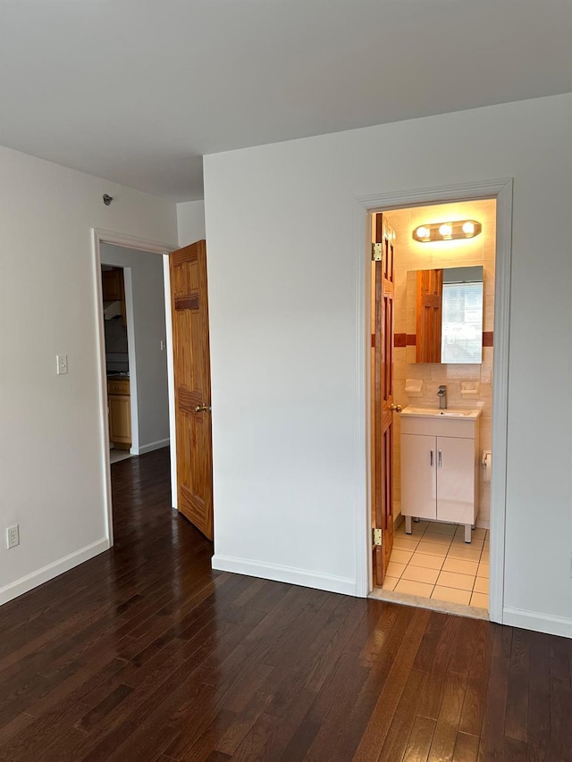 empty room featuring sink and hardwood / wood-style flooring